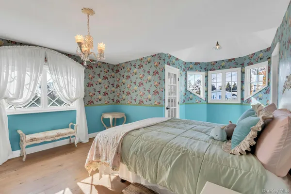 a bedroom with a bed and windows