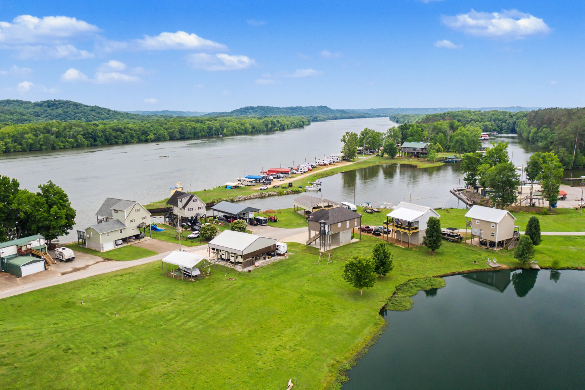 175 Ellen Lane Decaturville, TN 38329 - Photo 7 of 25 a view of a lake with lawn chairs and a table