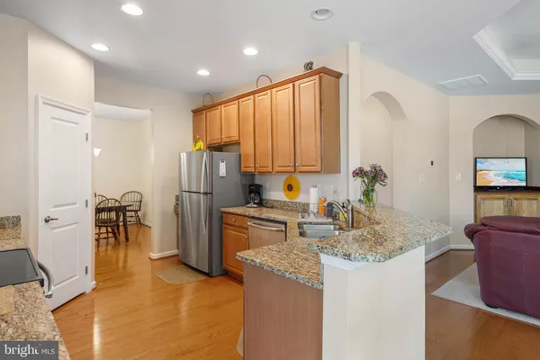 a kitchen with refrigerator and cabinets