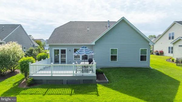 a view of house with a yard and porch