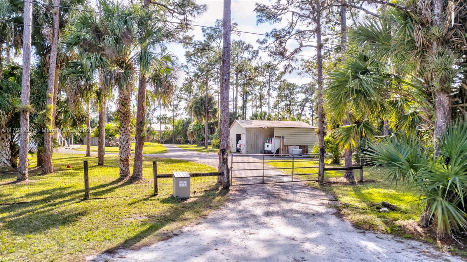 13724 Farley Road Loxahatchee, FL 33470 - Photo 54 of 61 a view of a swimming pool with a patio and a yard