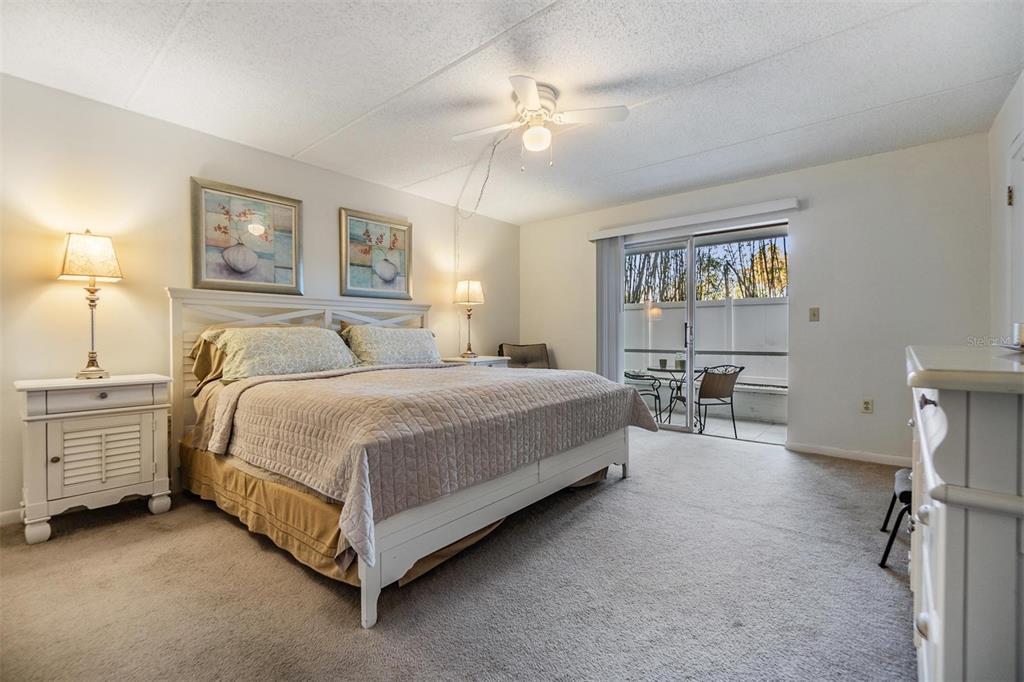 12760 Indian Rocks Road, Unit 104 Largo, FL 33774 - Photo 16 of 37 a spacious bedroom with a bed and a chandelier