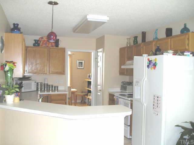 5205 Denmead Way Raleigh, NC 27613 - Photo 3 of 12 You enter the kitchen from the dining room or from the main living area; the kitchen is light and open and has a breakfast bar plus a breakfast area