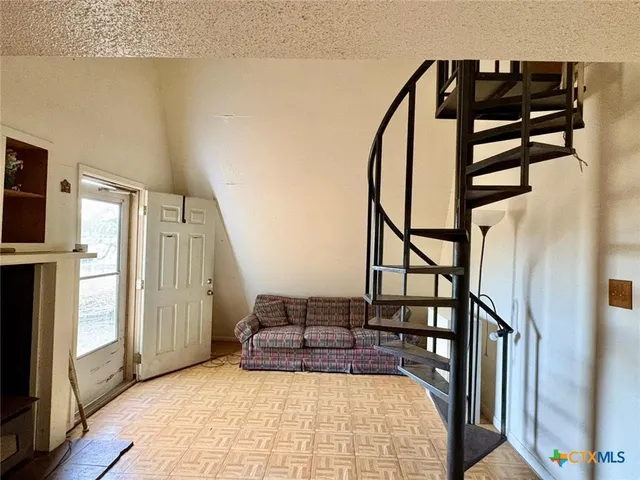 a dining room with furniture and a rug