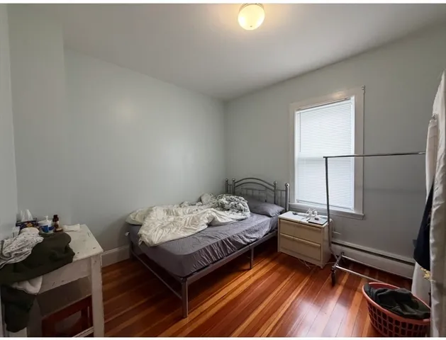 a bed sitting in a bedroom next to a window