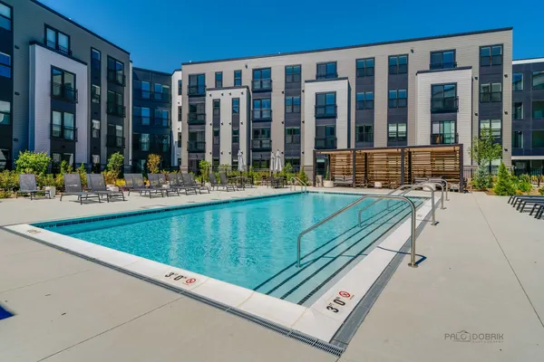 a view of a building and a yard with chairs