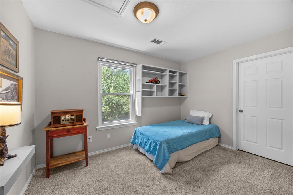 881 Wild Road Van Alstyne, TX 75495 - Photo 22 of 40 a bedroom with a bed and a window