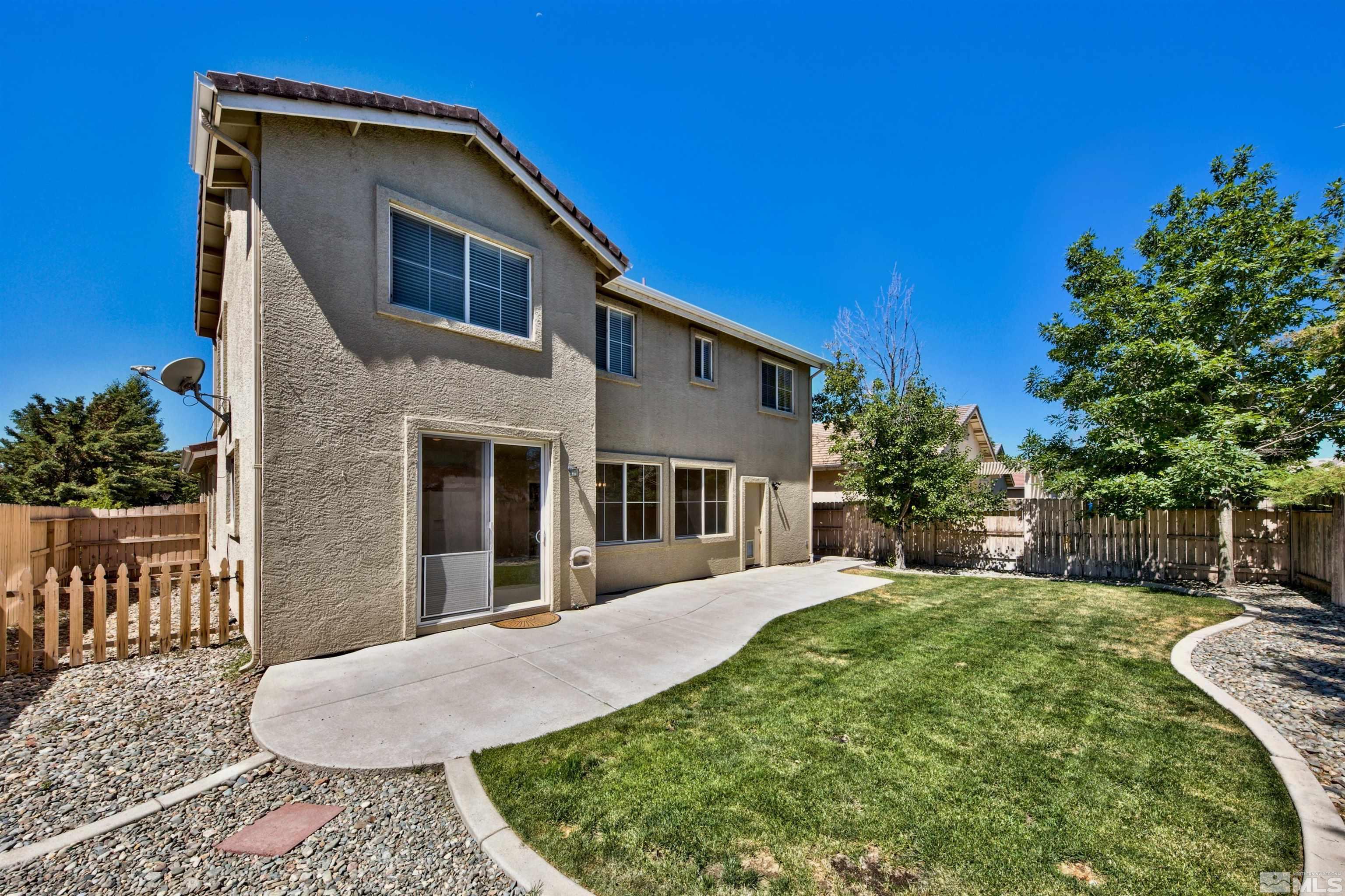 10084 Silver Star Drive Reno, NV 89521 - Photo 11 of 26 a front view of a house with garden