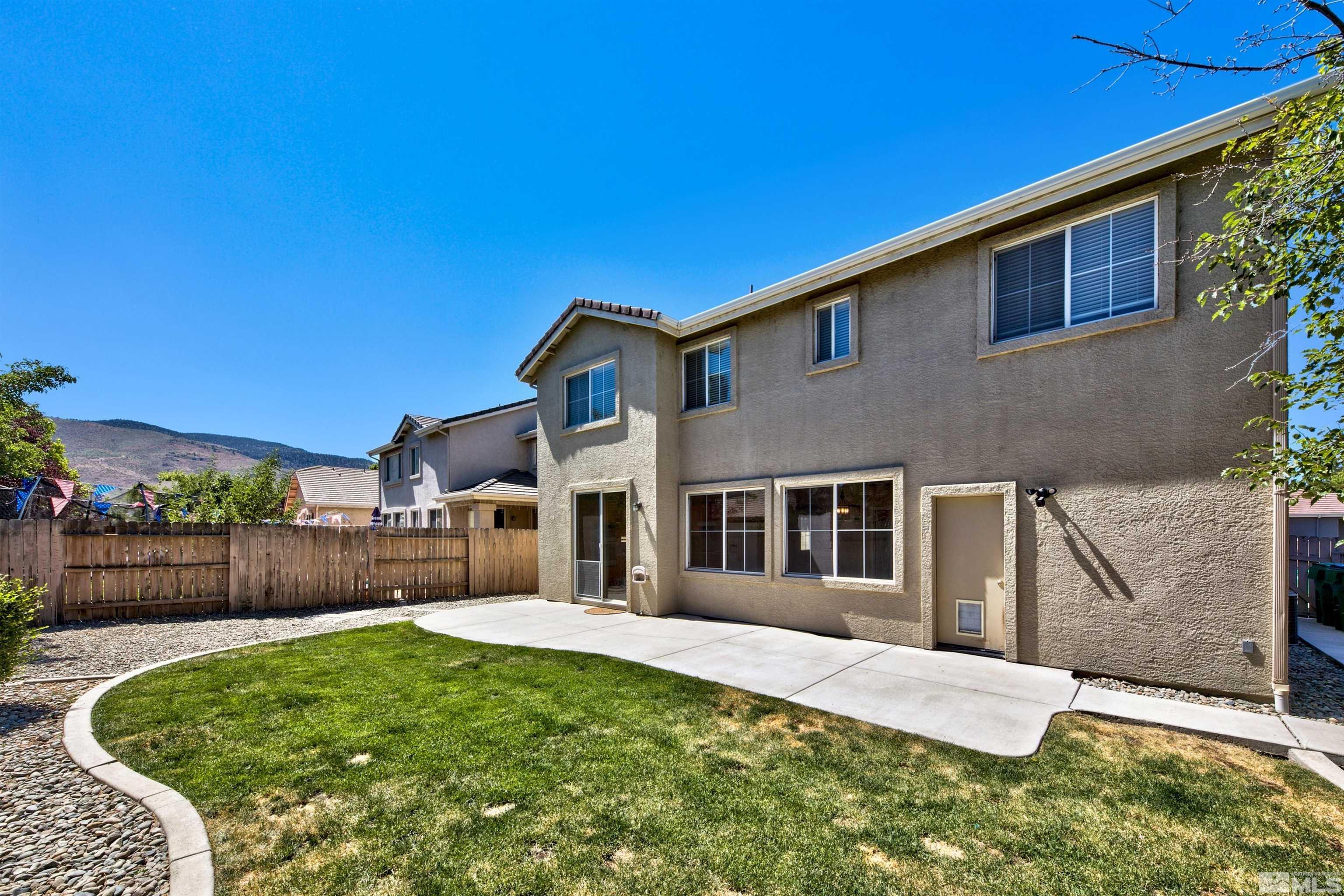 10084 Silver Star Drive Reno, NV 89521 - Photo 12 of 26 a front view of a house with a yard