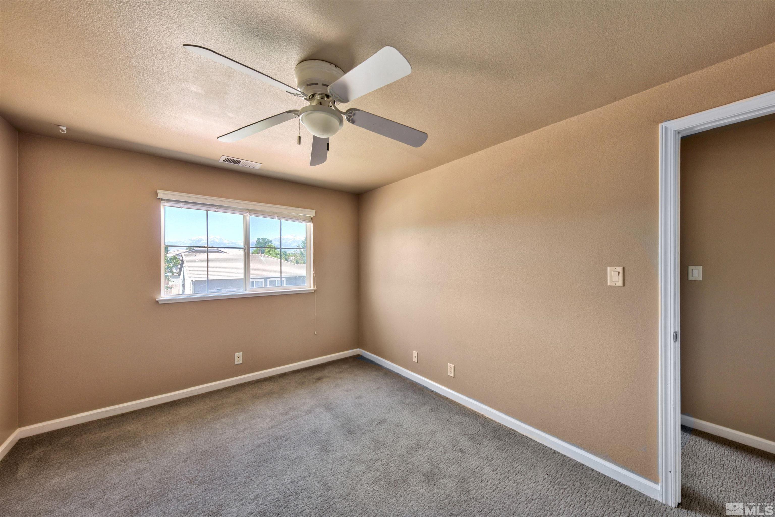 10084 Silver Star Drive Reno, NV 89521 - Photo 17 of 26 a view of an empty room with a window