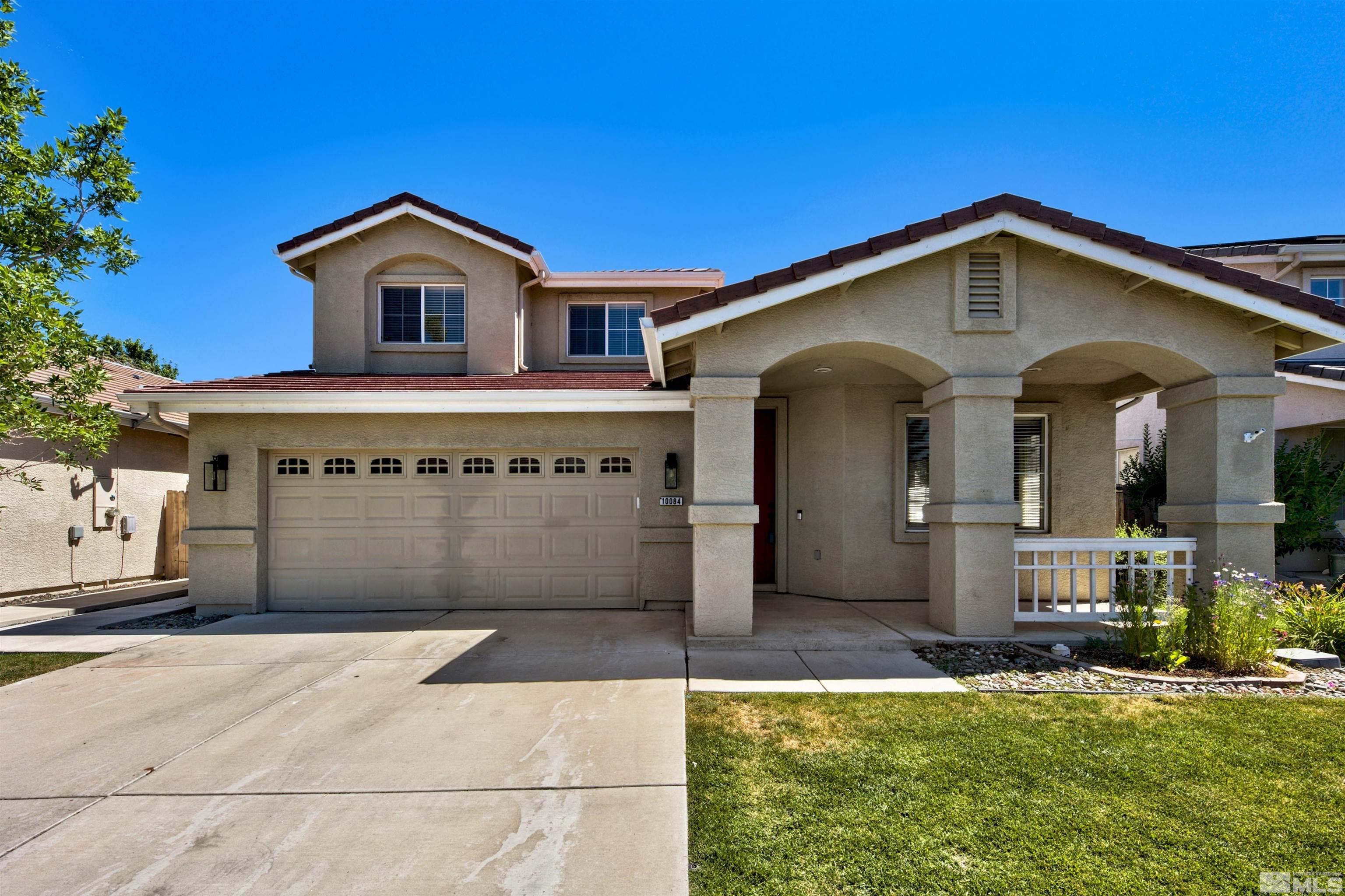 10084 Silver Star Drive Reno, NV 89521 - Photo 25 of 26 a front view of a house with a yard