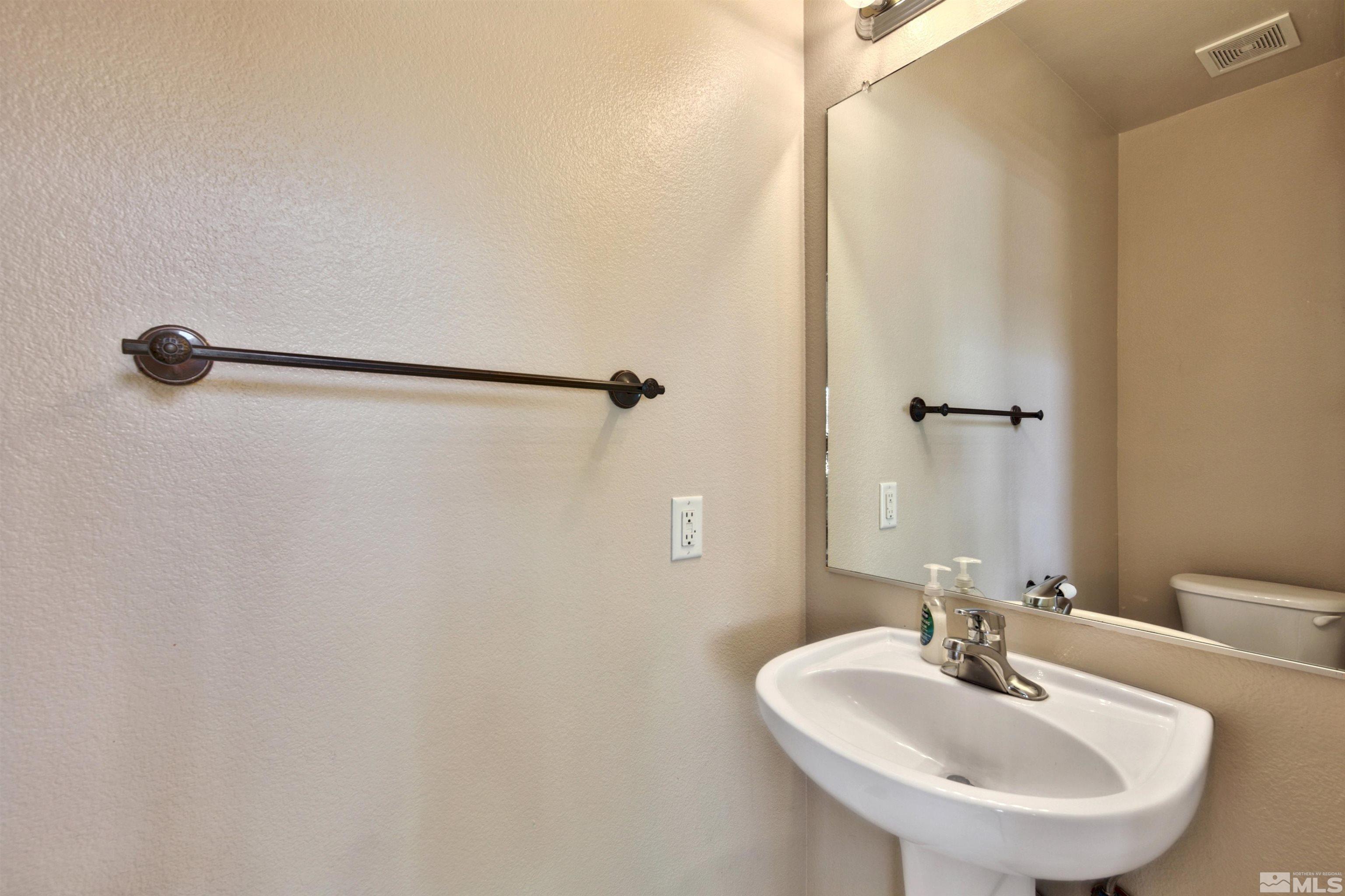 10084 Silver Star Drive Reno, NV 89521 - Photo 10 of 26 a bathroom with a sink and a mirror