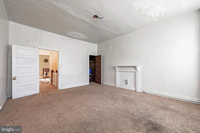 a view of empty room with wooden ceiling