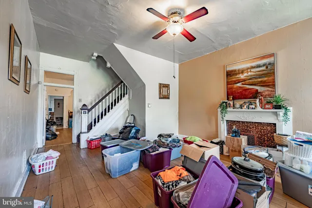 a living room with furniture a chandelier and a large window