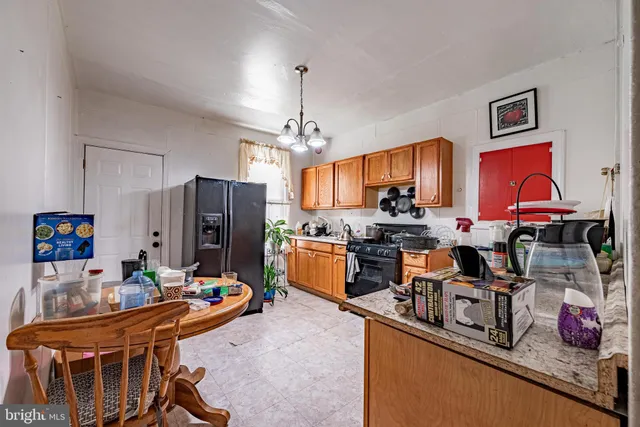 a dining room with furniture and a potted plant