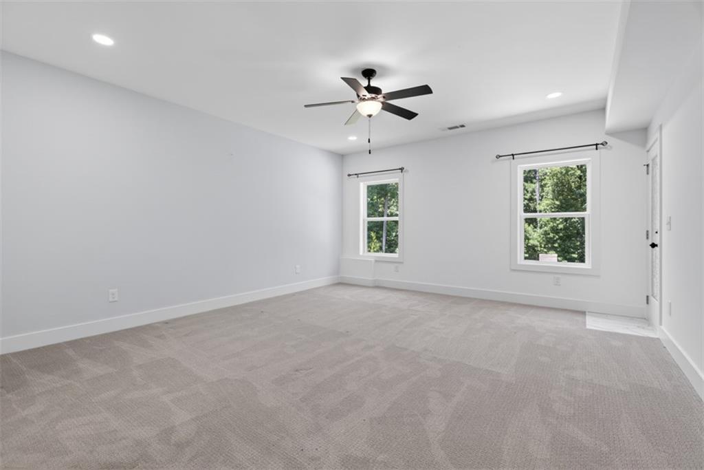 3528 North Bogan Road Buford, GA 30519 - Photo 66 of 79 an empty room with windows and fan