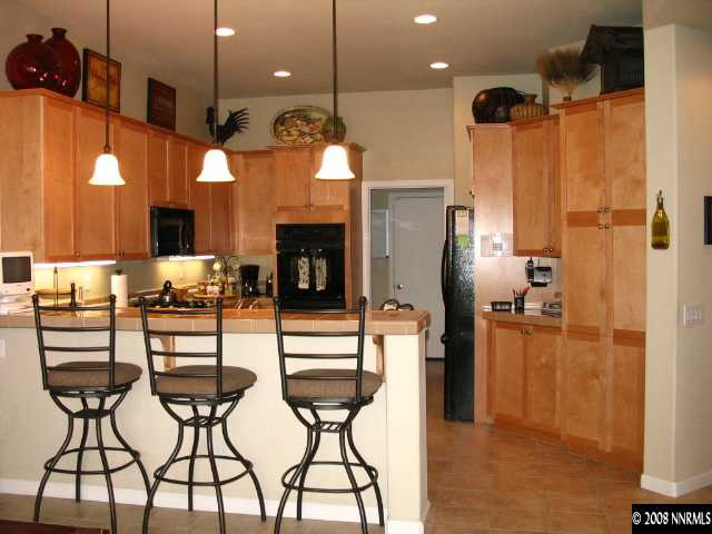 1550 Caughlin Creek Road Reno, NV 89519 - Photo 1 of 9 a kitchen with stainless steel appliances kitchen island granite countertop a refrigerator and microwave