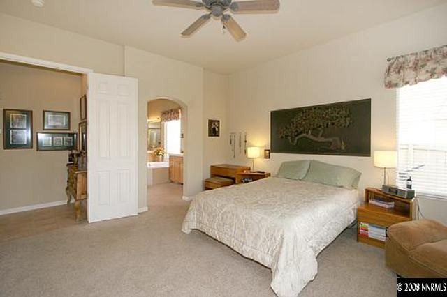 1550 Caughlin Creek Road Reno, NV 89519 - Photo 5 of 9 a bedroom with a bed and a chandelier