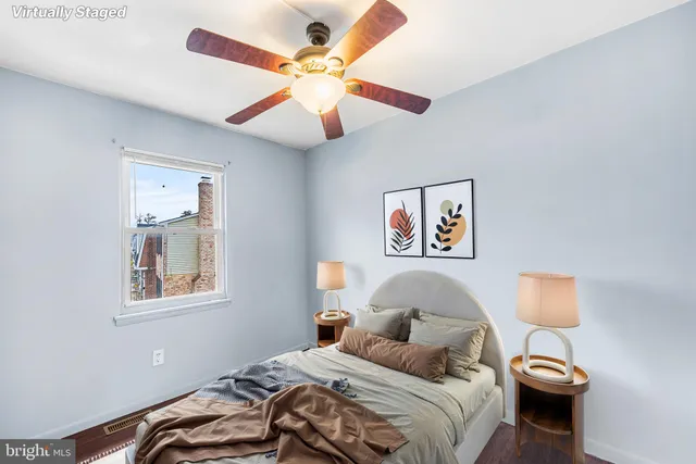 a bedroom with a bed and a painting on the wall