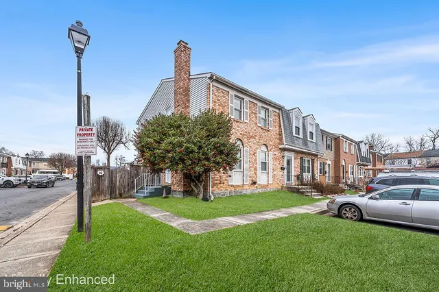 a front view of multiple houses with yard