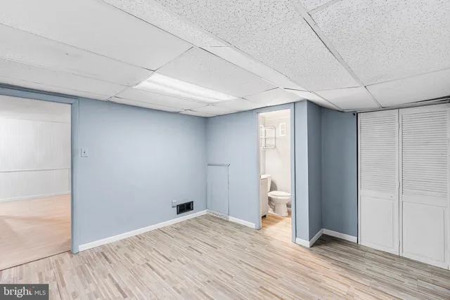 a view of a room with wooden floor and a ceiling fan
