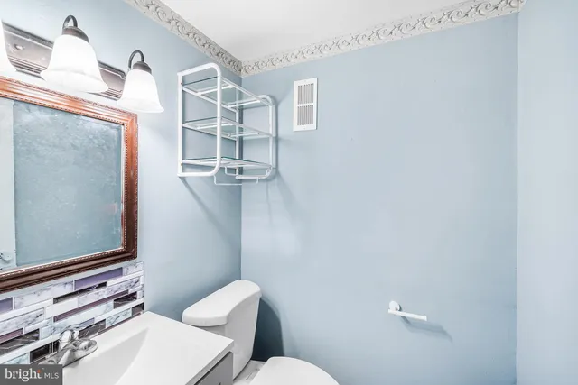 a white toilet sitting next to a bathroom sink
