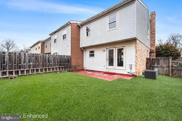 a view of backyard with deck and garden