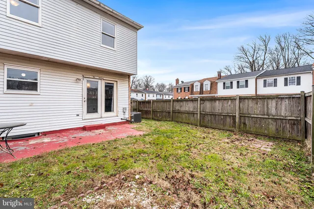a view of backyard with wooden fence