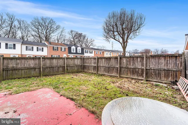 a view of a backyard with a fence