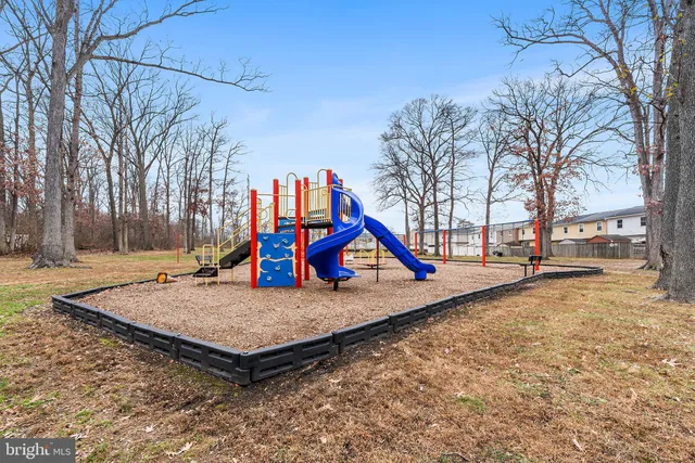 a view of outdoor space with playground and green space