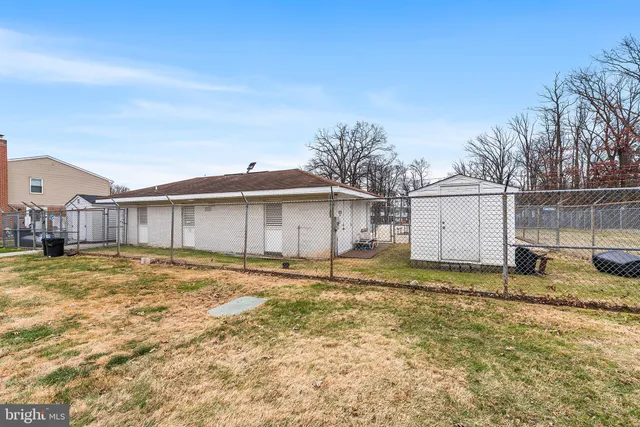 a view of a yard with wooden fence