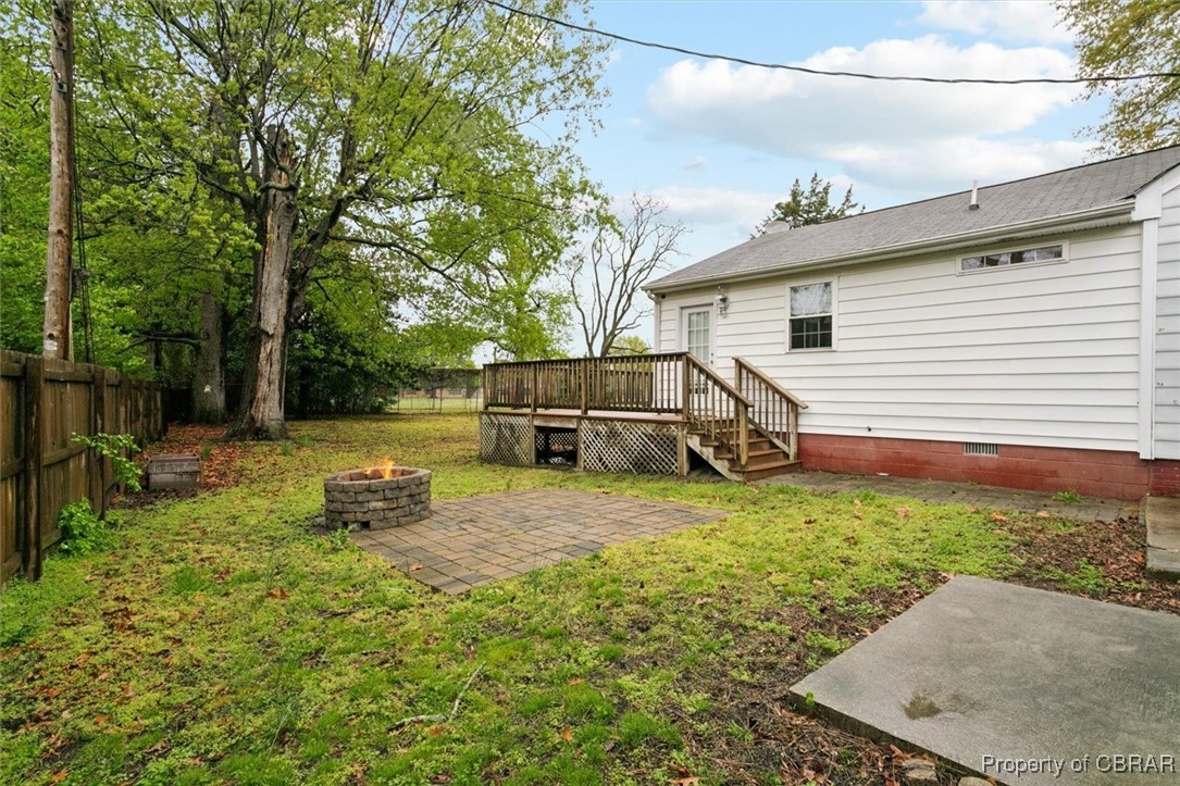 345 Fox Hill Road Hampton, VA 23669 - Photo 39 of 46 View of yard featuring a deck, a patio area, a fenced backyard, and a fire pit
