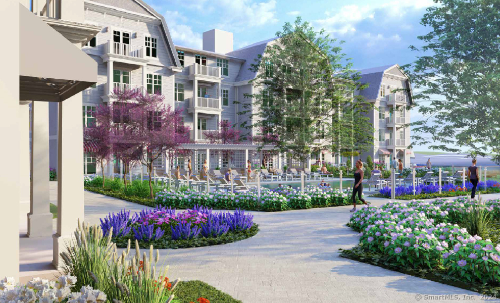 52 Maple Street, Unit 101 Branford, CT 06405 - Photo 6 of 12 a front view of a multi story residential apartment building with yard and bench