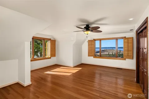 a bathroom with a sink a toilet a mirror and shower curtain