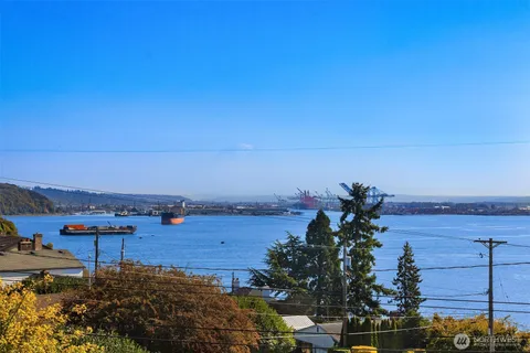 a view of empty room with fireplace and wooden floor