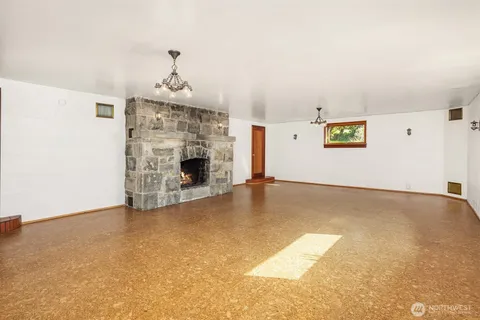 an aerial view of ocean and residential houses with outdoor space