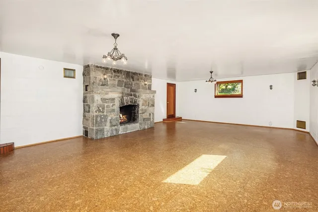 an aerial view of ocean and residential houses with outdoor space