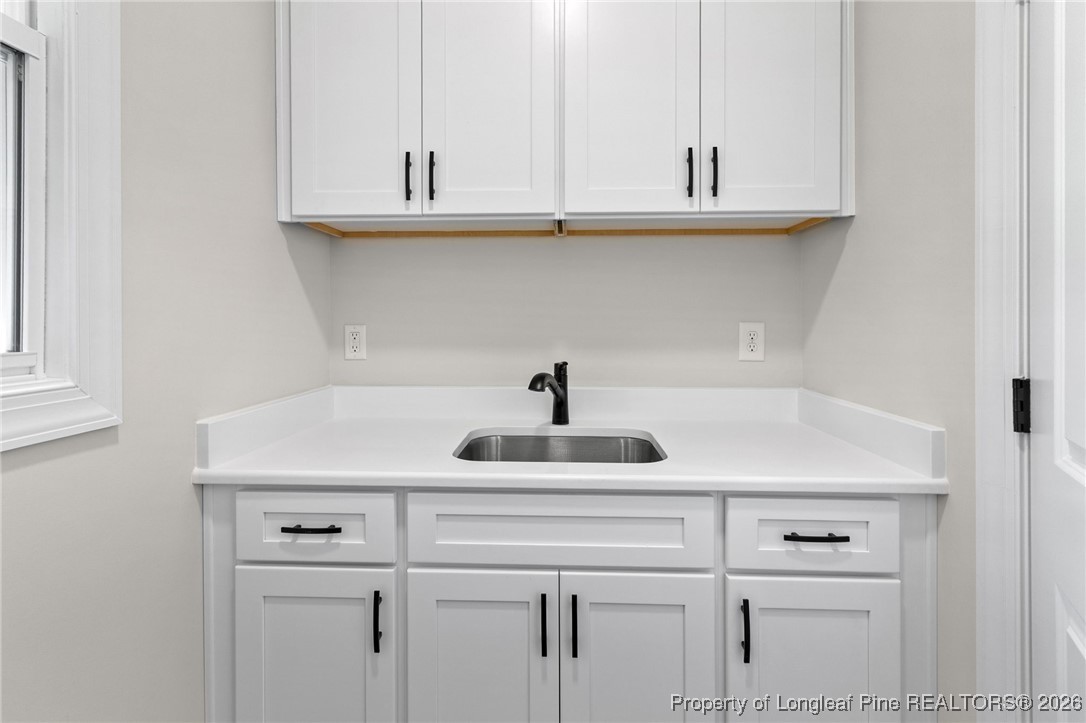 944 Rhum Drive Fayetteville, NC 28311 - Photo 21 of 49 a kitchen with a sink and cabinets