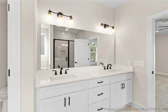a bathroom with double sink and a mirror