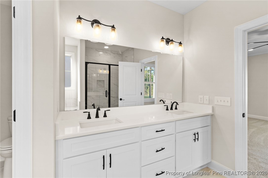 944 Rhum Drive Fayetteville, NC 28311 - Photo 29 of 49 a bathroom with double sink and a mirror