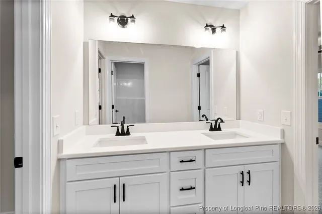 a bathroom with a sink vanity and mirror