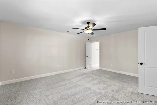 a view of an empty room with a fan