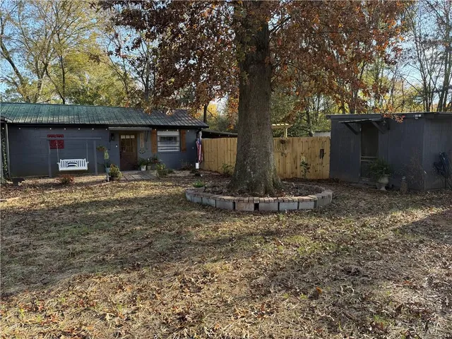 a backyard of a house with table and chairs