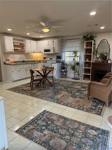 a kitchen with stainless steel appliances kitchen island granite countertop a sink and cabinets