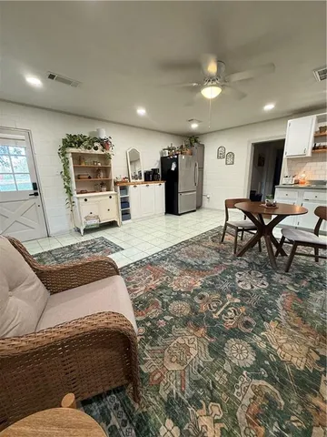 a living room with furniture and kitchen view