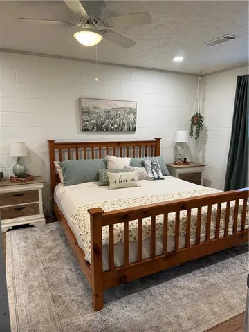 a bed sitting in a bedroom next to a window