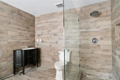a bathroom with a toilet and a shower