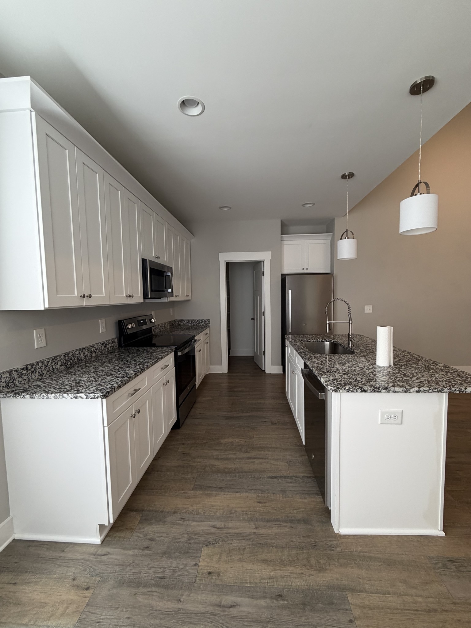 442 Bill Fuson Road McMinnville, TN 37110 - Photo 11 of 29 a large kitchen with stainless steel appliances a sink a stove and a wooden floors
