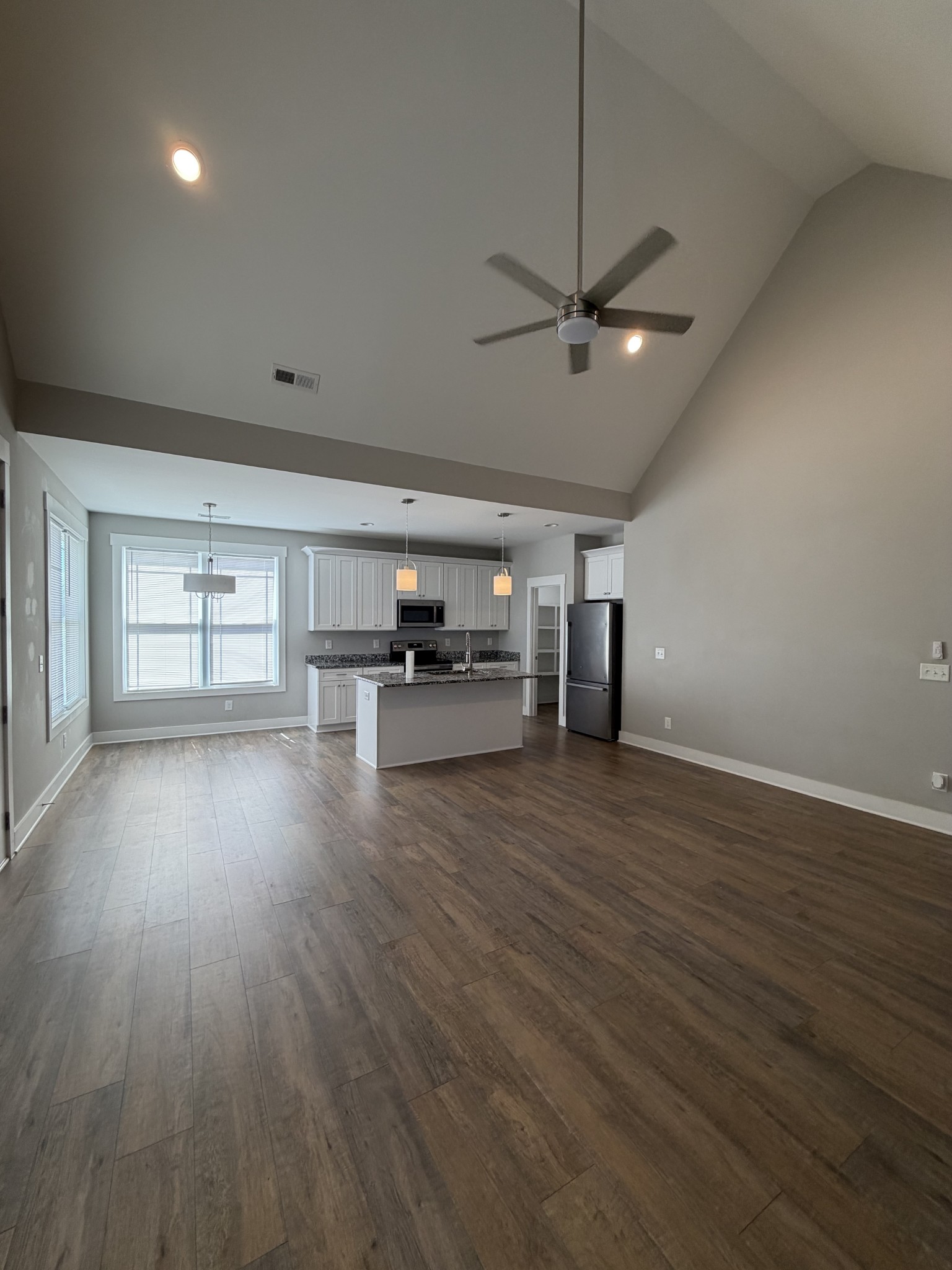 442 Bill Fuson Road McMinnville, TN 37110 - Photo 16 of 29 a view of a livingroom with furniture hardwood floor ceiling fan and windows