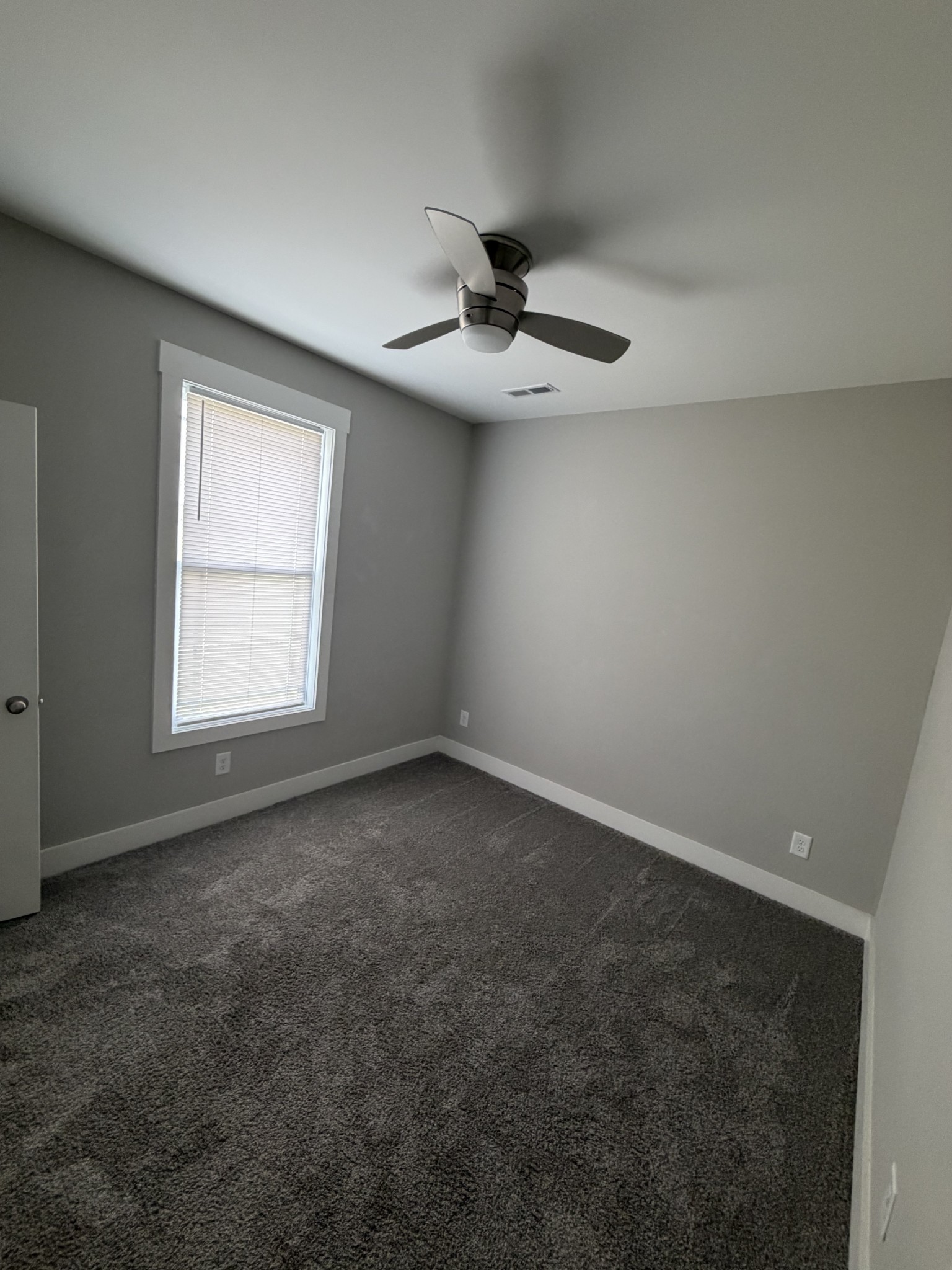 442 Bill Fuson Road McMinnville, TN 37110 - Photo 25 of 29 an empty room with a window and a ceiling fan